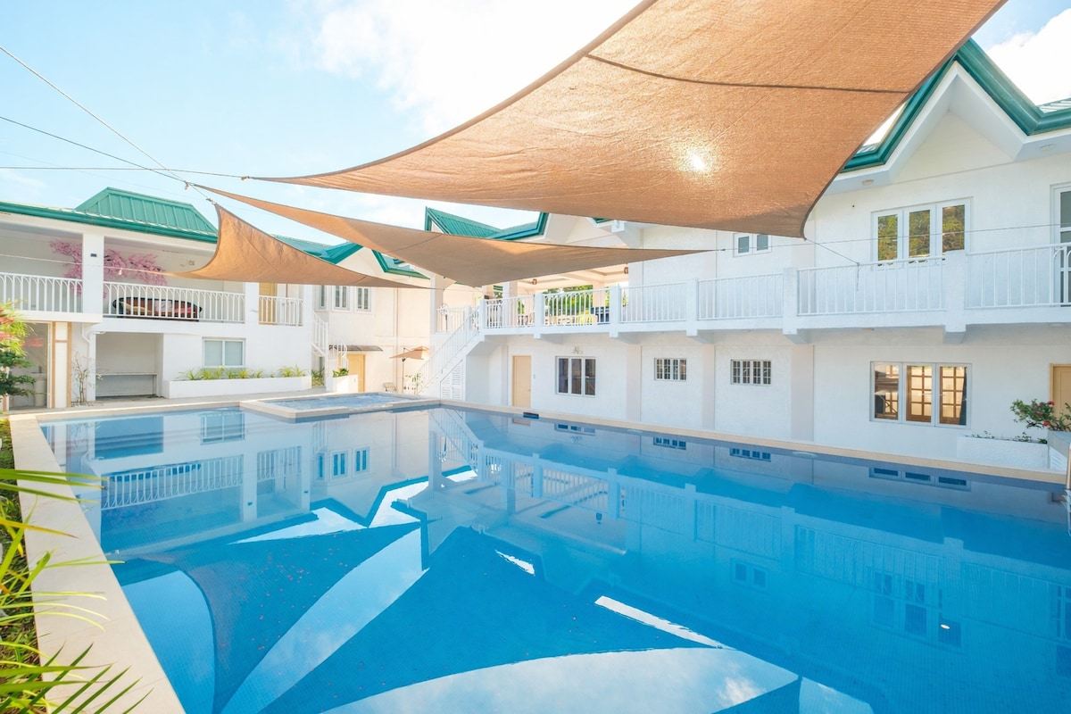 Casa Sakura's pool and white villa on a sunny morning