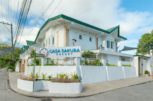 Casa Sakura Resort entrance and sign by day